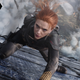 Scarlett Johansson's Black Widow hangs on for dear life to the side of a plane crashing through the atmosphere.